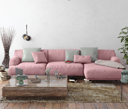 Een lichtroze Chaise lounge met grijze en roze kussens in een woonkamer